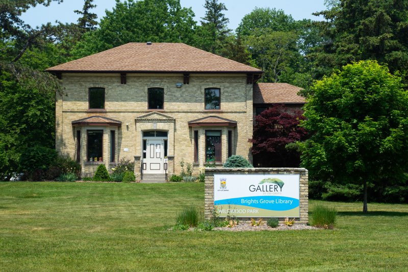 Faethorne House today: a two-storey yellow-brick house with a Gallery in the Grove and Bright’s Grove Library sign on the lawn