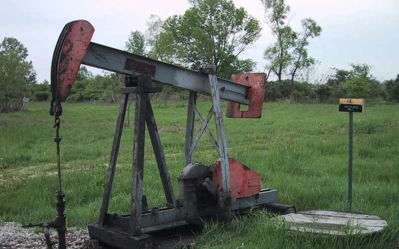 A historic oil pumpjack standing in a field near Petrolia