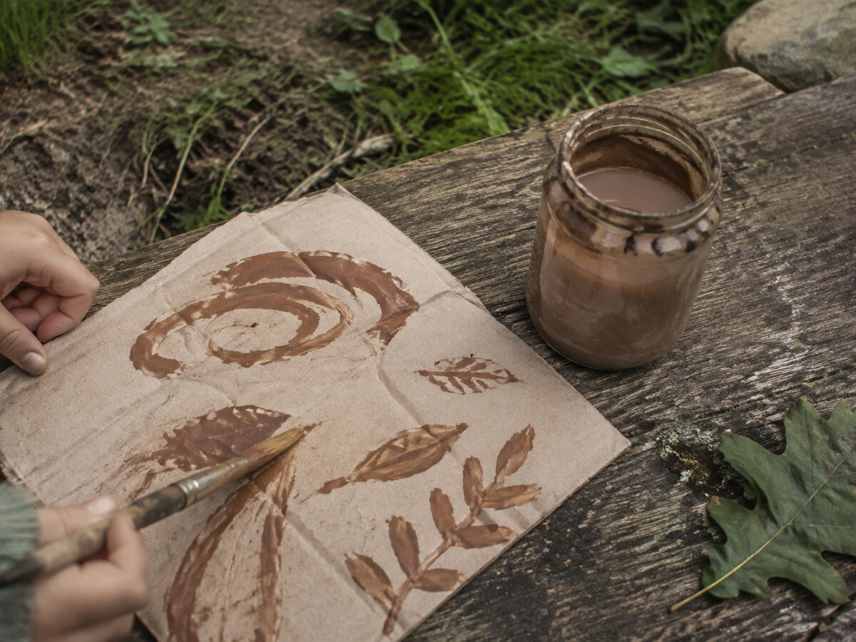 Mud paint studio with soil, water, and outdoor paintings