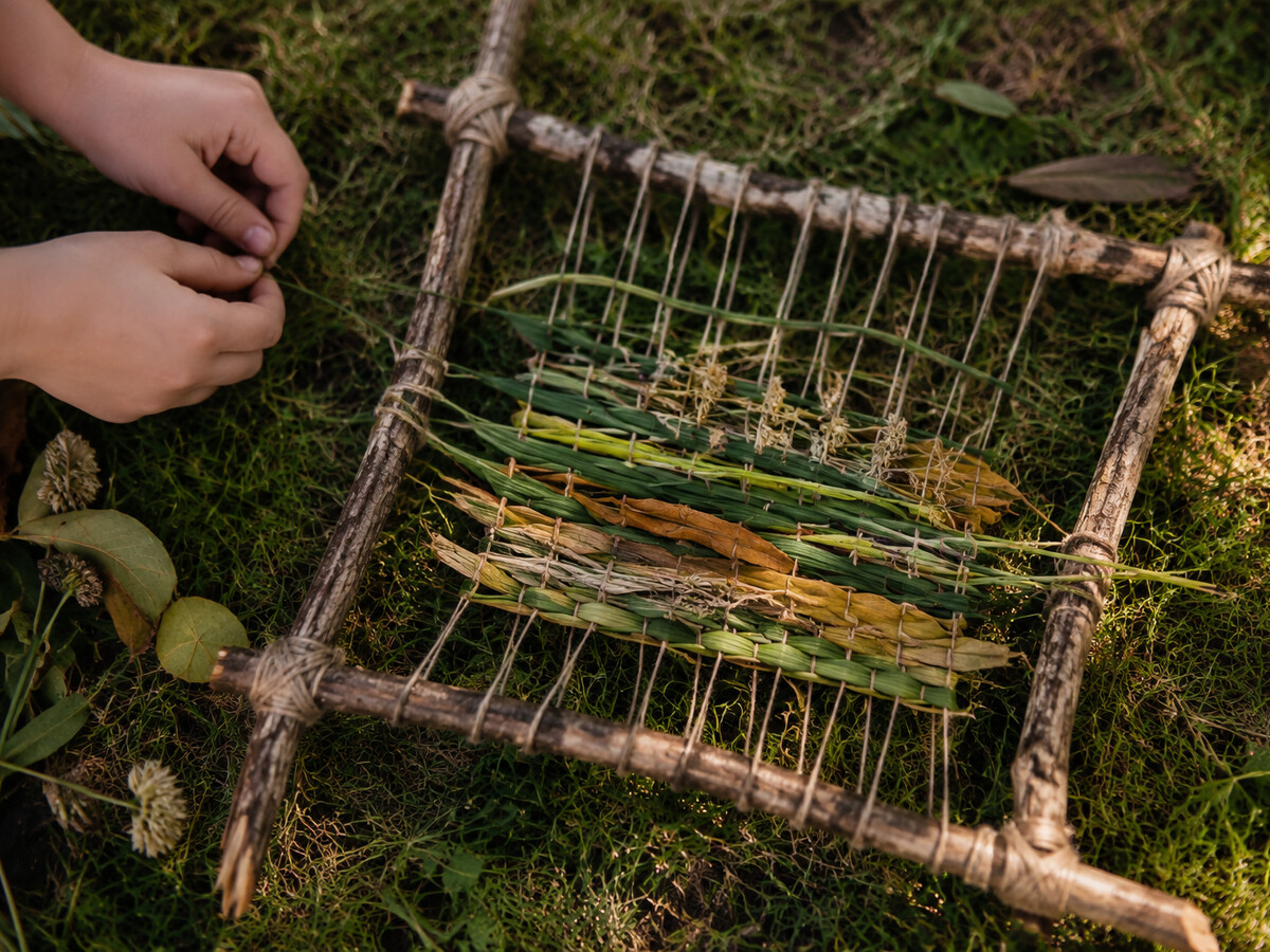 Nature weaving made with sticks, string, grass, and leaves
