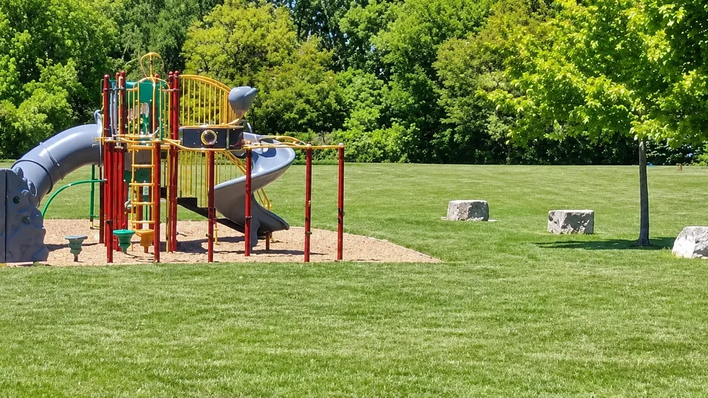 Playground structure and open lawn at Autumn Breeze Park in Sarnia