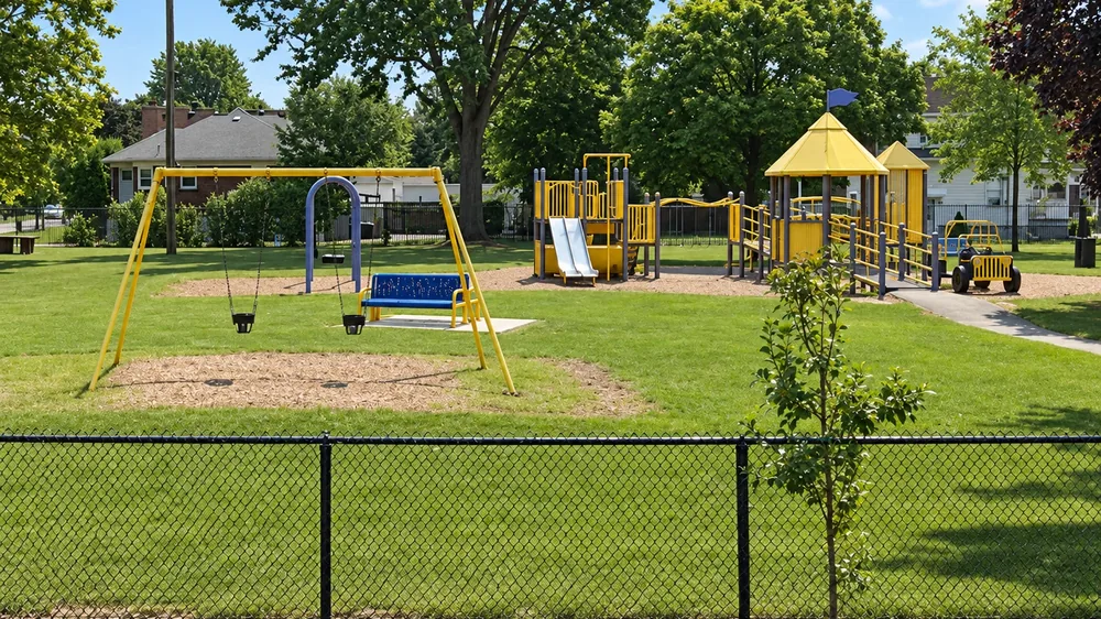 Yellow playground, swings and accessible play structure at Lion’s Park in Sarnia