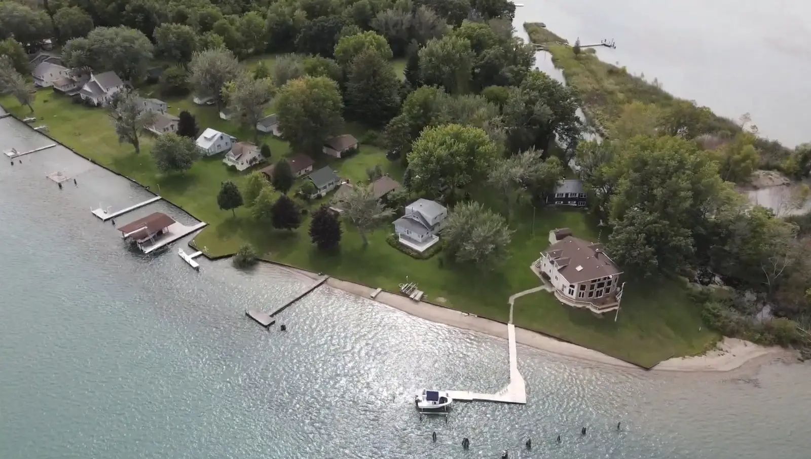 Cottages, lawns and docks along the shoreline of Stag Island